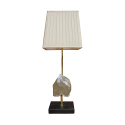 A “By Moinat” light fixture adorned with a transparent rock crystal stone, a brushed brass base