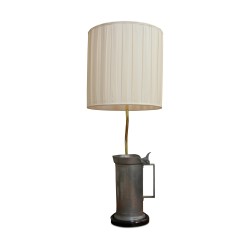 A “By Moinat” light fixture decorated with a pewter measuring pot, a wooden base with a lampshade