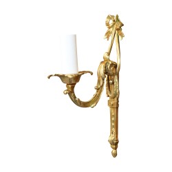 A Louis XVI style light fixture in gilded bronze and old patina