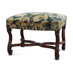 A Louis XIV seat in richly carved walnut covered in “Aux popvots” fabric