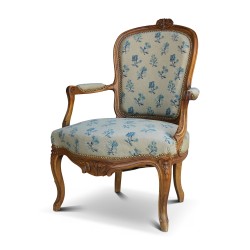 Une assise Louis XV cabriolet grand modèle en noyer, richement sculpté.