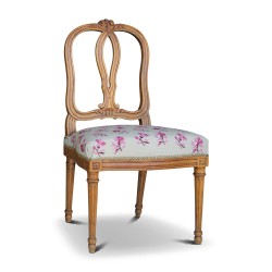 A richly carved Louis XV seat and Louis XVI legs in walnut. Bernoise.