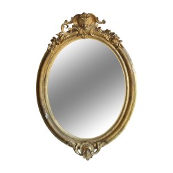 A richly molded Napoleon III oval mirror in gilded wood, mercury glass