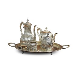 A richly carved silver tea and coffee service.