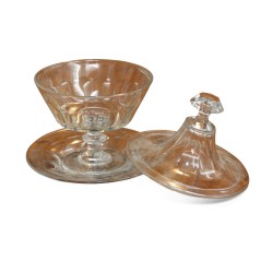 A glass cup with lid and stand.