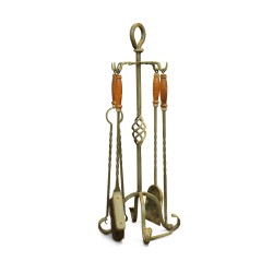 A set of wrought iron fireplace tools with wooden handles