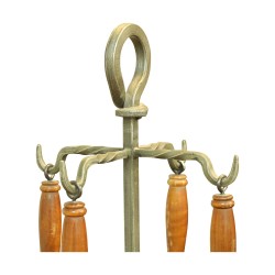 A set of wrought iron fireplace tools with wooden handles