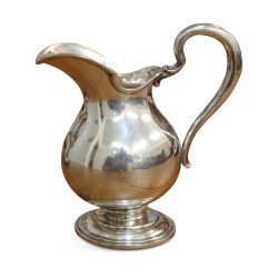 A silver-plated milk jug