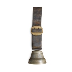 A bronze cowbell with a leather collar