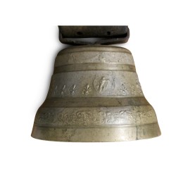 A bronze cowbell with a leather collar