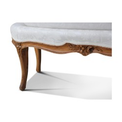 A Louis XV seat in walnut, covered with a beige fabric. Work from Lyon. France.