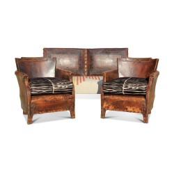 A seating set including a sofa and two leather armchairs, velvet cushion