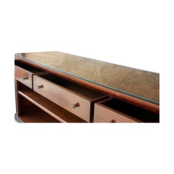 A cherry wood sofa back console with glass top. Three drawers and a shelf.