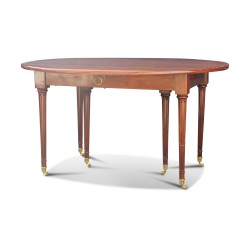 A Louis XVI mahogany dining table, fluted legs with castors