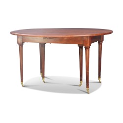 A Louis XVI mahogany dining table, fluted legs with castors