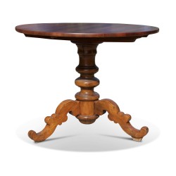 A round, tripod walnut dining table.