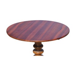 A round, tripod walnut dining table.