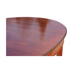 A cherry wood directoire dining table with extension.